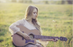 a lady playing a guitar